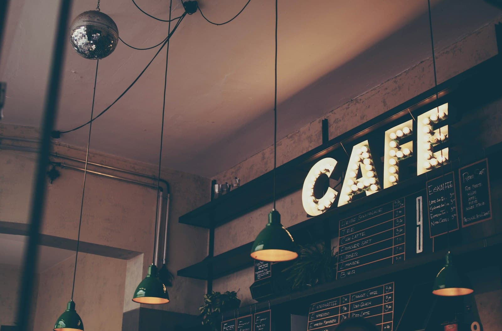 Café interior with pendant lights and a counter sign