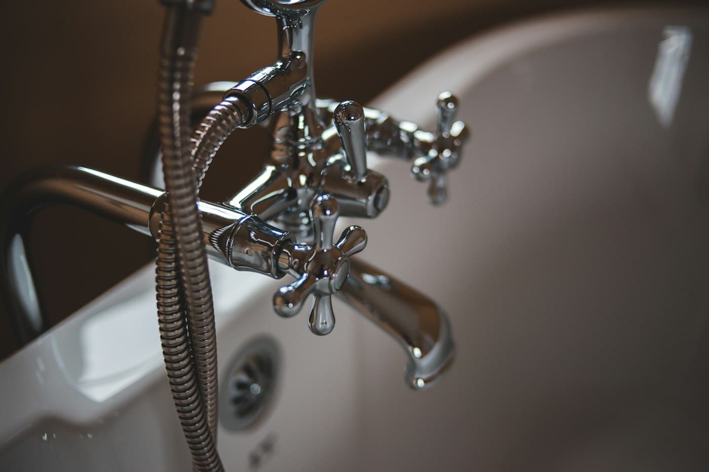 Chrome bathroom faucet and handles on white tile